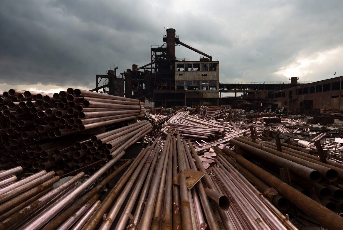 Organized copper pipes and tubes ready for industrial use in a factory yard